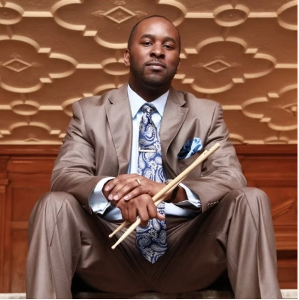 Travien Bryson holding drumsticks